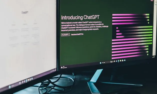 Computer with Two Monitors Displaying ChatGPT